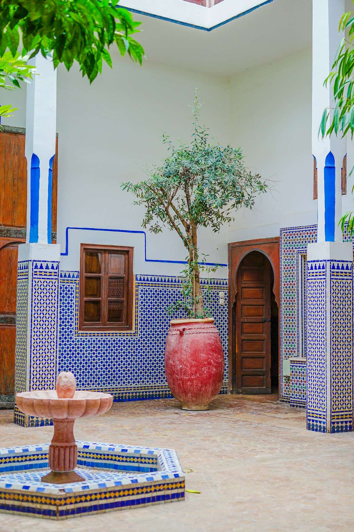 Moroccan riad courtyard with ornate zellige tilework and central fountain