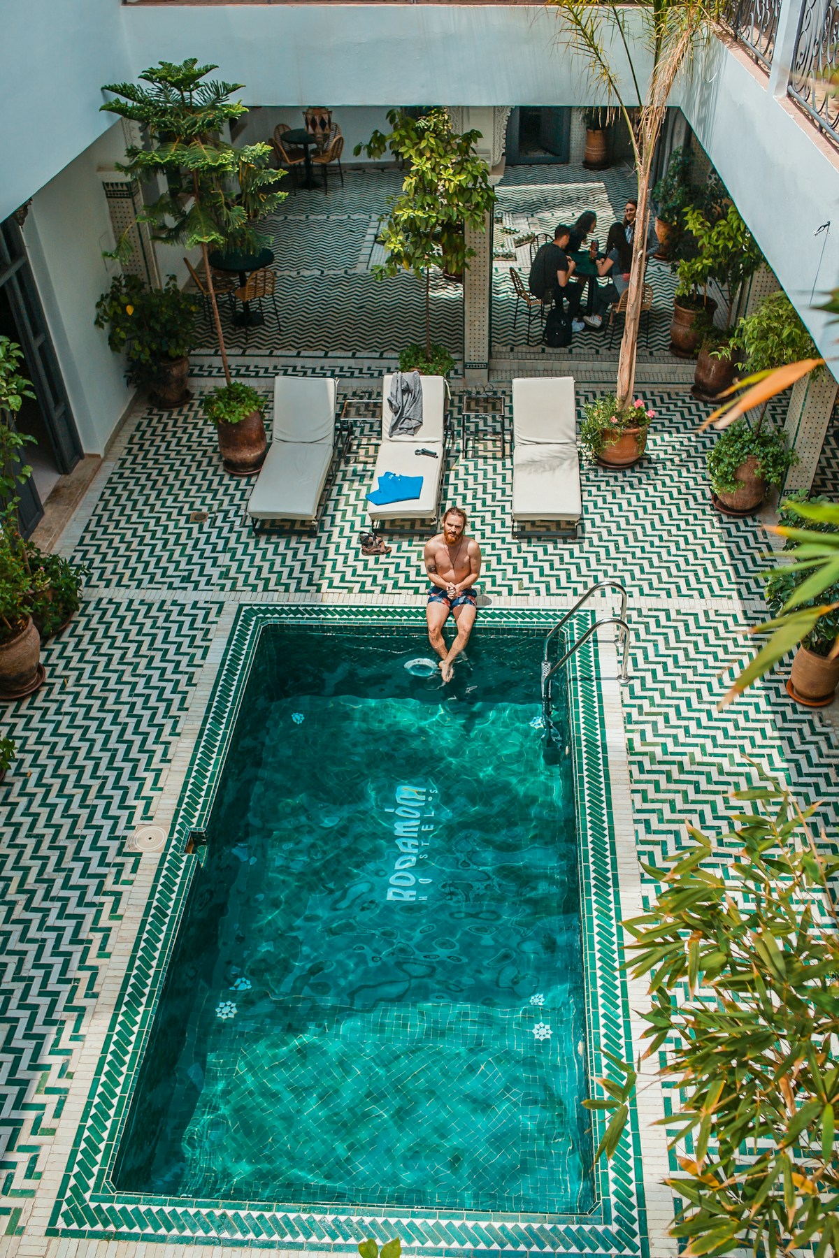 Riad courtyard with zellige tiled pool and garden